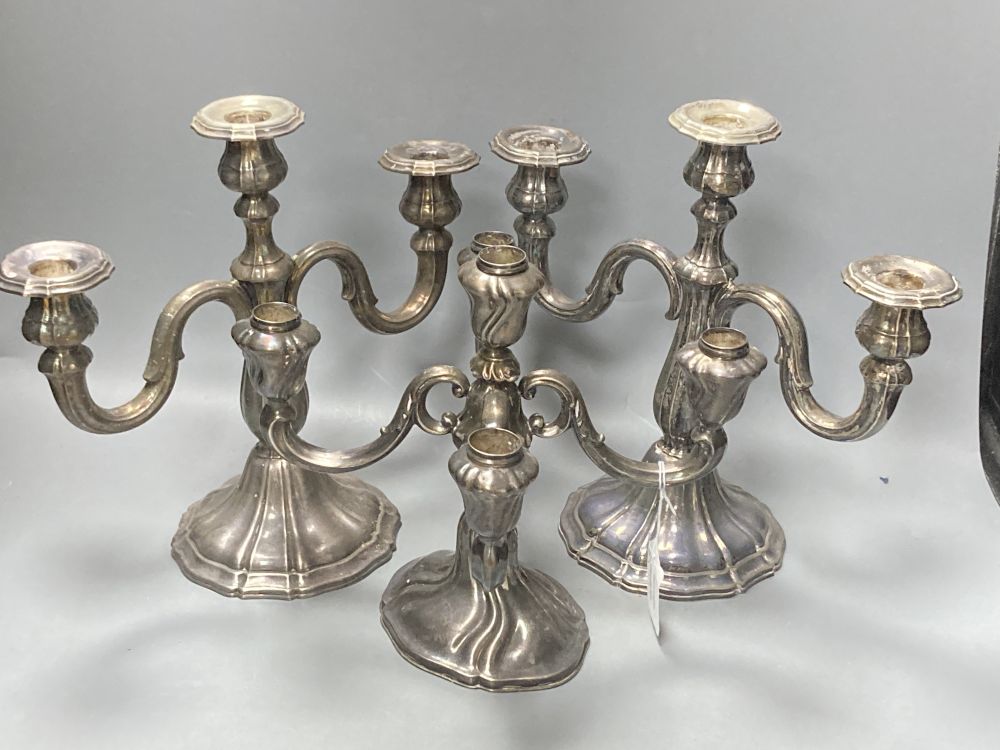 An early 20th century German 925 standard candelabrum and pr of candelabra